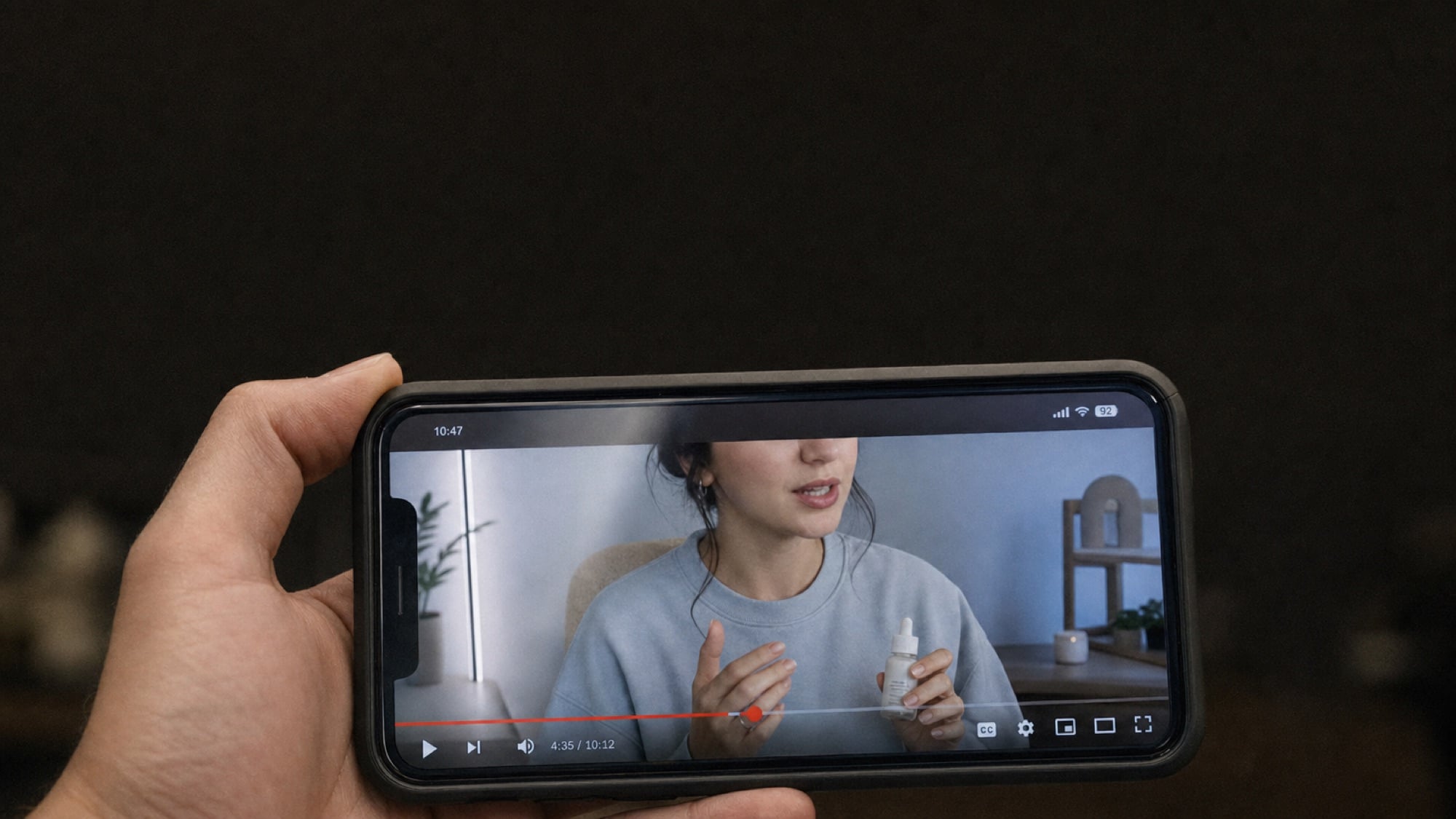 Three phones showing the same clip as an organic post, a paid ad, and a boosted post.